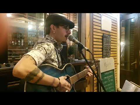 Chris Zayane singing on the street for a crowd of beautiful girls