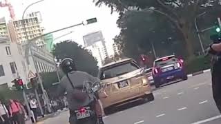 A car changed lanes without properly checking for an approaching bike.