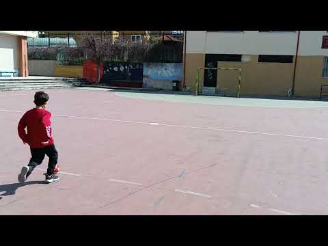 Dimitris doing football challenge at his school.