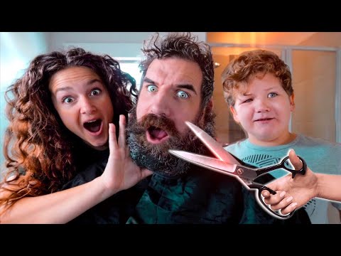 A bearded man with surprised expressions, flanked by a woman and a child, as a pair of scissors hovers near his beard in a playful scene.