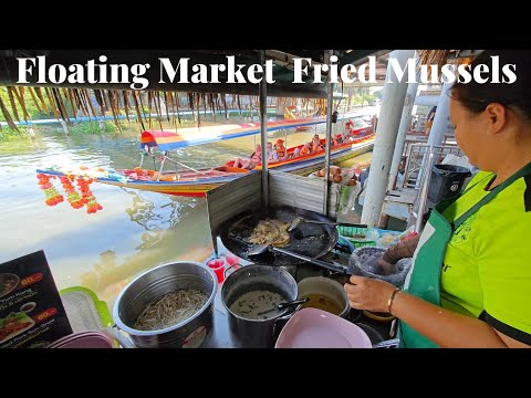 Satisfied with cooking Fried Mussels at the floating market.
