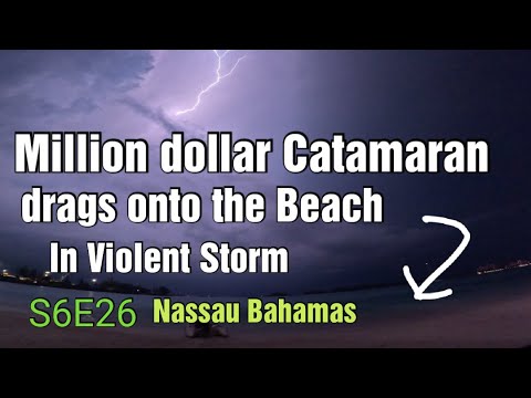 Big Catamaran goes right up on the beach during thunderstorm. S6E26