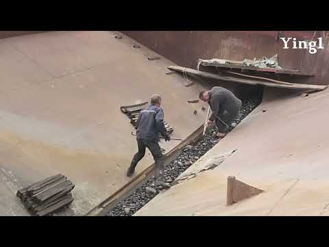 Unloading 2500 tons of large size cobblestone . Hard work requires a lot of experience