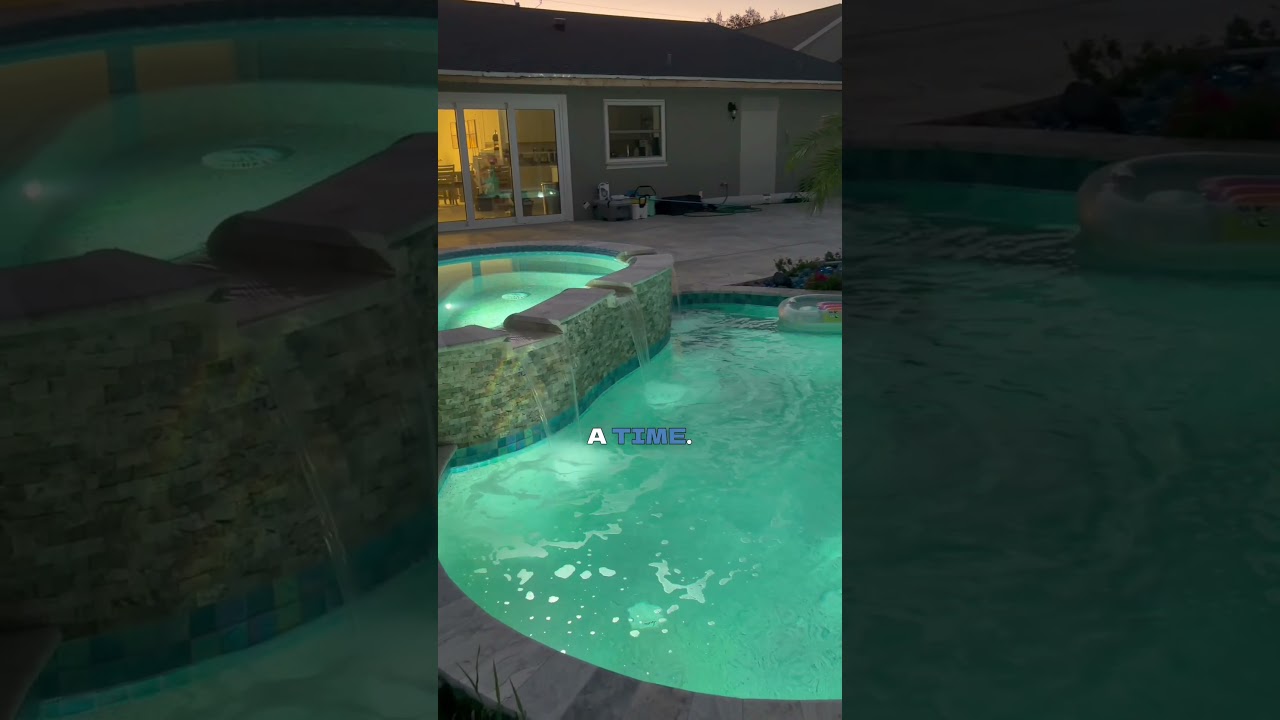 Palm Coast Custom Freeform Waterfront Pool with Raised Spa & Fire Bowls #palmcoast #poolbuilder