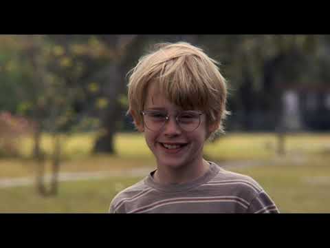 Trailer collage of parades, bike rides, and small-town fairs that match upbeat needle-drops