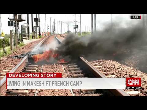 Migrants are forcing their way onto trucks in Calais to hitch a ride from France to the UK