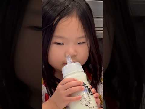 Drinking yogurt in a baby bottle