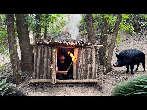 Building a primitive survival shelter escaping from a wild boar