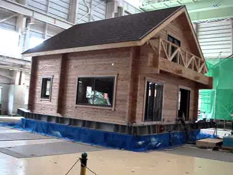 Log house on earthquake test
