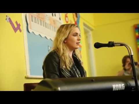 Molly Sterling singing "Playing With Numbers" for pupils at her old school