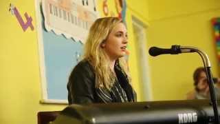 Molly Sterling singing "Playing With Numbers" for pupils at her old school