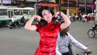 GIRL DANCES IN BUSY SAIGON TRAFFIC