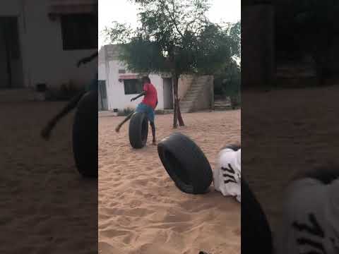 Children playing on tyres in Thiès, Senegal