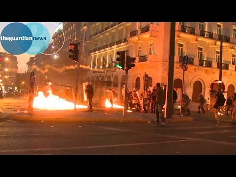 Greek anti-austerity protesters throw petrol bombs at police