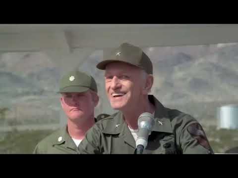 Hair trailer still with the tribe gathered under a night sky, evoking the musical’s communal vibe