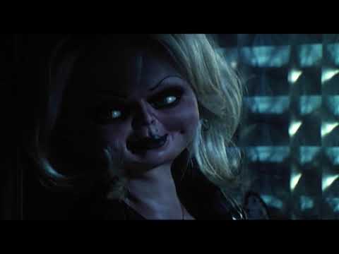 Trailer still: a speeding black car at night as headlights streak past