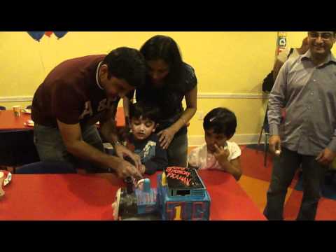 Pranav cutting his Thomas Train cake