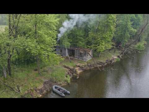 thunderstorm and rain in an abandoned anglers shelter , catch and cook