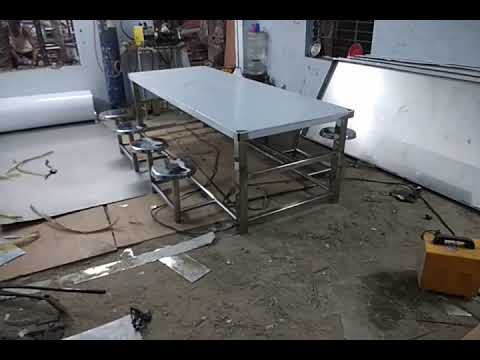 Stainless steel dining table with folding chairs