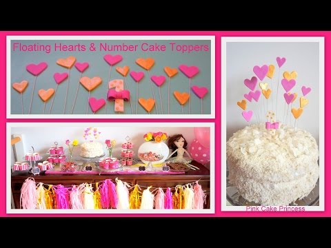 Part of a video titled How to Make Floating Hearts & Number 1 Cake Toppers Decorations