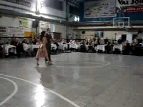  Sofiani Figueroa  and  John Erban  are  dancing  to  the  tango  "  El Recodo etc.  "