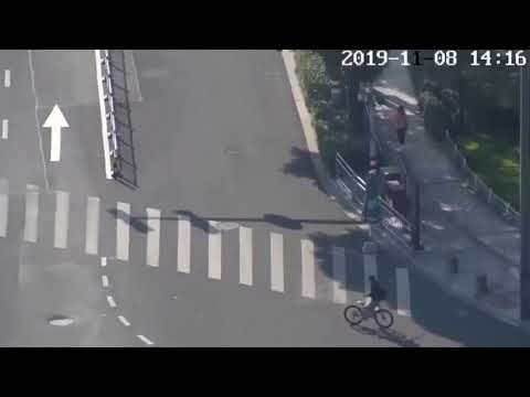 Cyclist With Toy Gun Rides Backwards In Busy Traffic