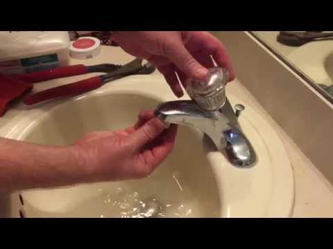 Cleaning the faucet aerator from hard water buildup.
