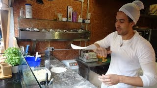 A Pizza Spinning Master in Action - Italian Pizzeria Shop seen in Camden Stables Market, London.....