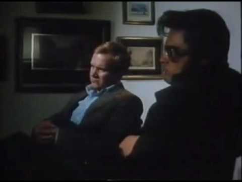 Kurt Russell as Elvis shoots out a TV screen