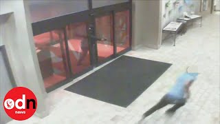 Man throws himself through hotel doors to escape gunfire