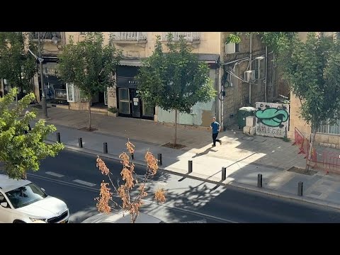 People run for cover and air raid sirens sound in Jerusalem following missile from Yemen | AFP