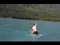 Canadian man rides moose at lake in British Columbia