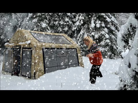 COZY TENT CAMP WITH STOVE IN HEAVY SNOWFALL