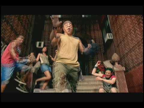 In the Heights Broadway TV spot still of the Washington Heights block with storefronts and stoops