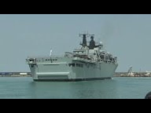 Migrants disembark HMS Bulwark