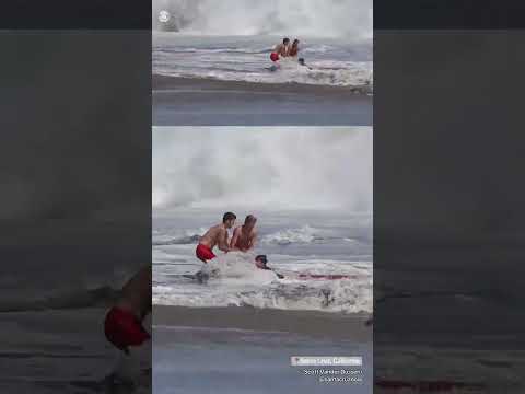 Teen lifeguard saves child from being swept away by massive waves #shorts