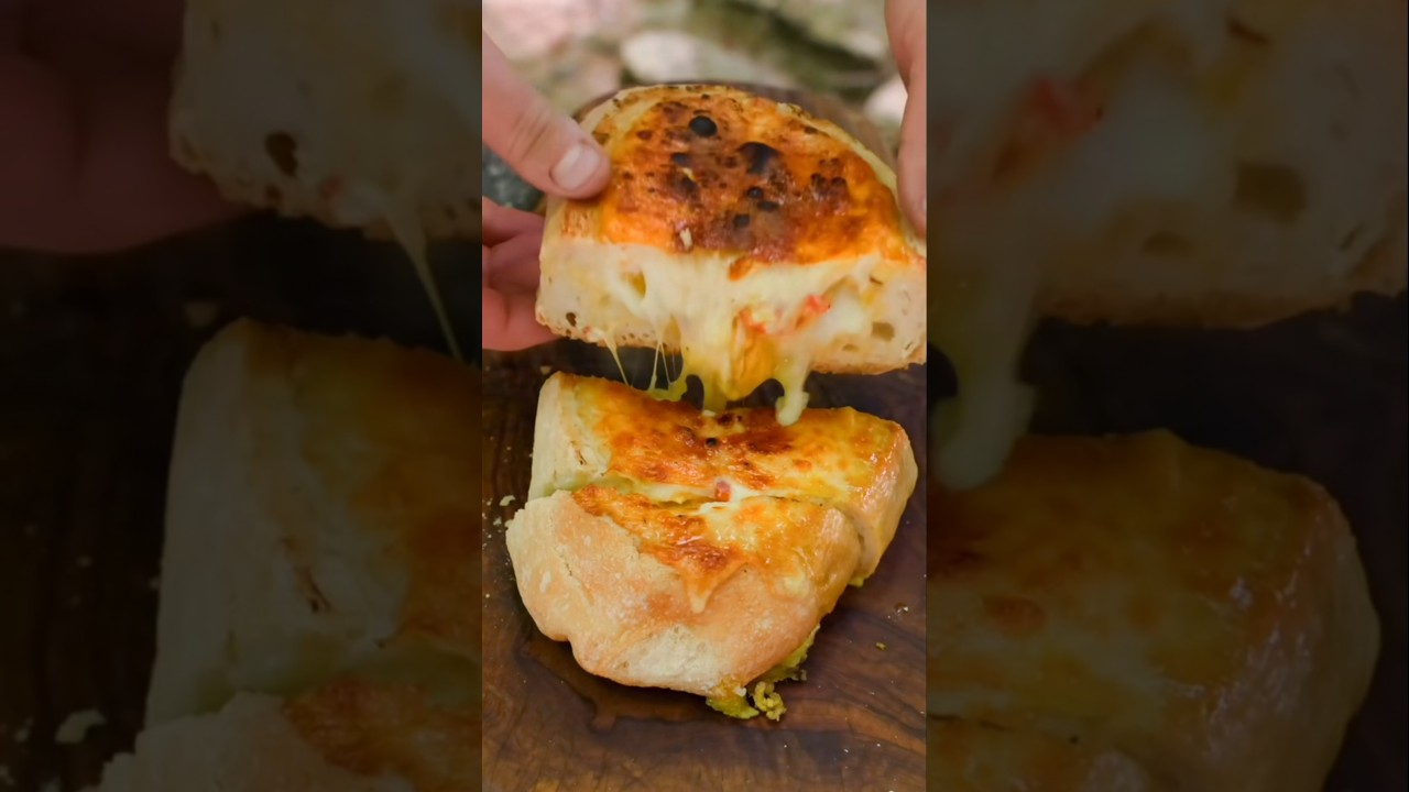 Ultimate Campfire Egg & Cheese Bread Bowl! 🤤🔥 #shorts #OutdoorCooking #CheesePull #Campfire