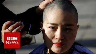 Shaving their heads in protest - BBC News