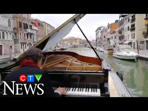 Italian pianist Paolo Zanarella performs while sailing down Venice canal