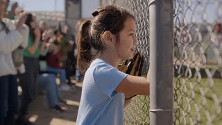  Spectator girl gets excited to watch a youth baseball team