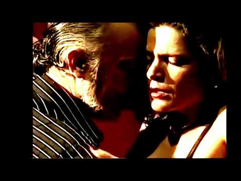  Carlos Gavito  and  Marcela Duran  are  dancing  to  the  tango  "  Una Emocion  "  by  Ricardo Tanturi