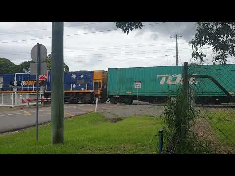 Pacific National container train passing through a crossing in south QLD