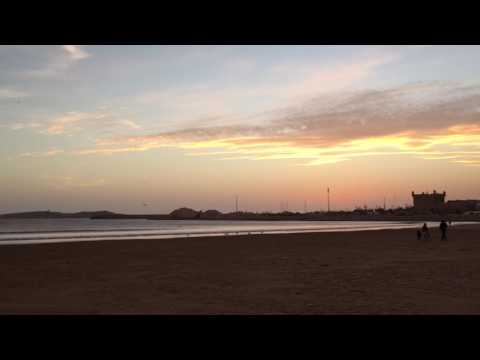 Blowing sand and sunset at beach in Essaouria, Morocco