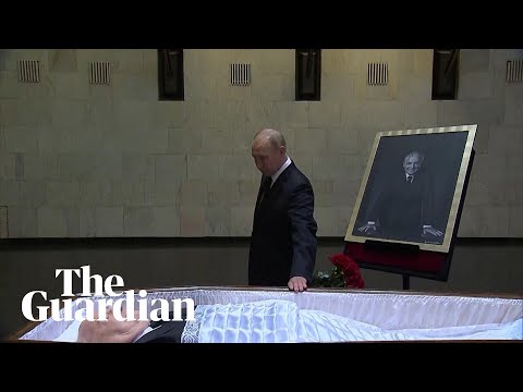 Vladimir Putin lays flowers next to open coffin of Mikhail Gorbachev