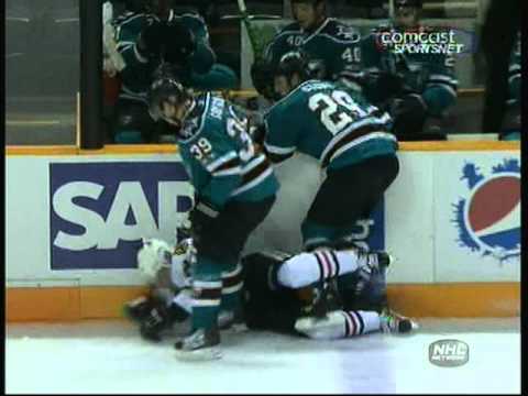 Ryane Clowe and Logan Couture sandwich Patrick Kane