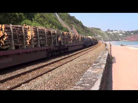 56094 passes Teignmouth along the sea wall with the logs to Chirk