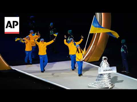 Russian woman carries Ukraine placard at Winter Olympics opening ceremony