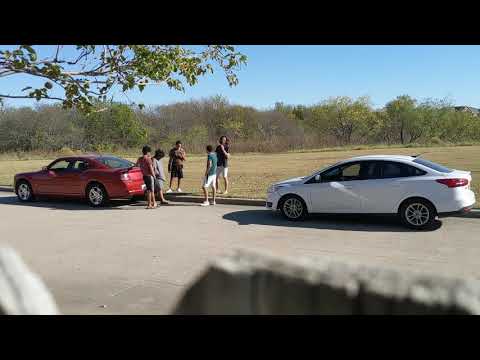 punks smoking something out of a plastic bottle