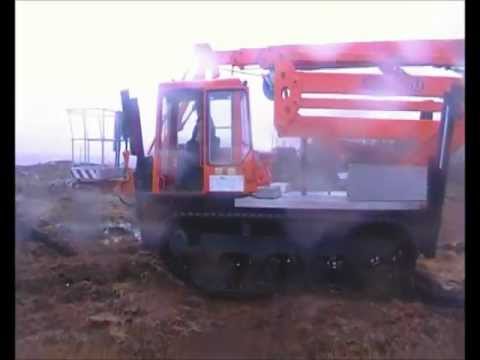 Isoli PNT280J lift on a Tracked Yanmar chassis driving off road.