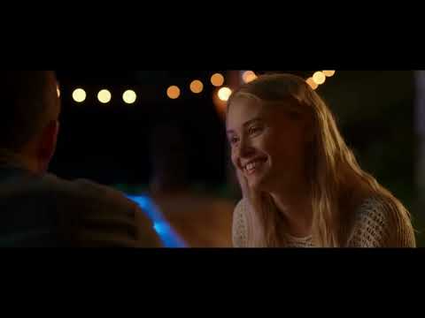 4K trailer title card: pink script logo over beachfront lights